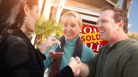 Hispanic,Female,Real,Estate,Agent,Handing,Over,New,House,Keys