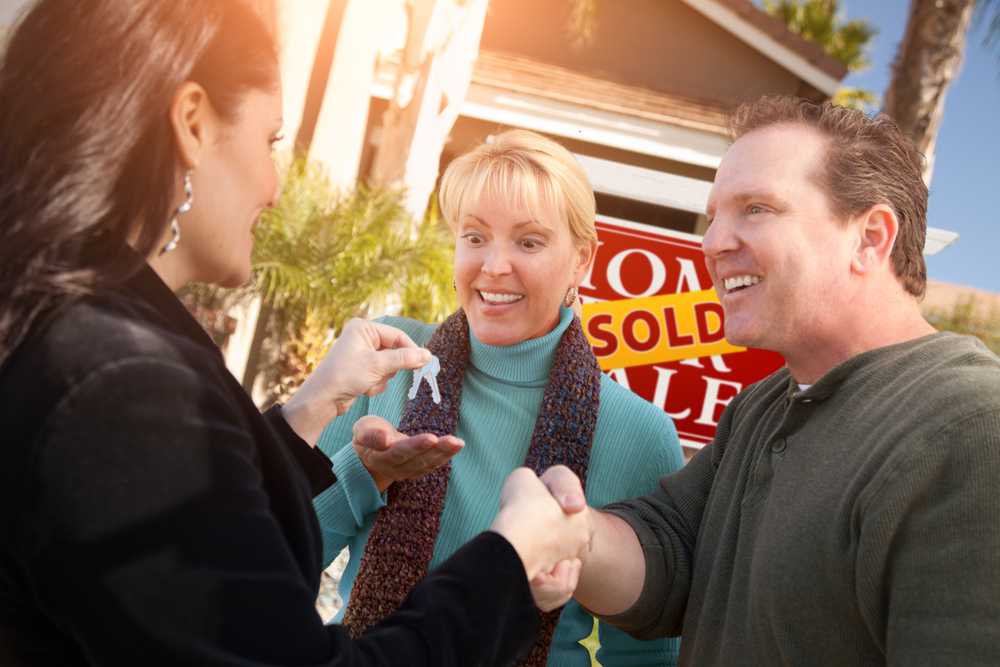 Hispanic,Female,Real,Estate,Agent,Handing,Over,New,House,Keys